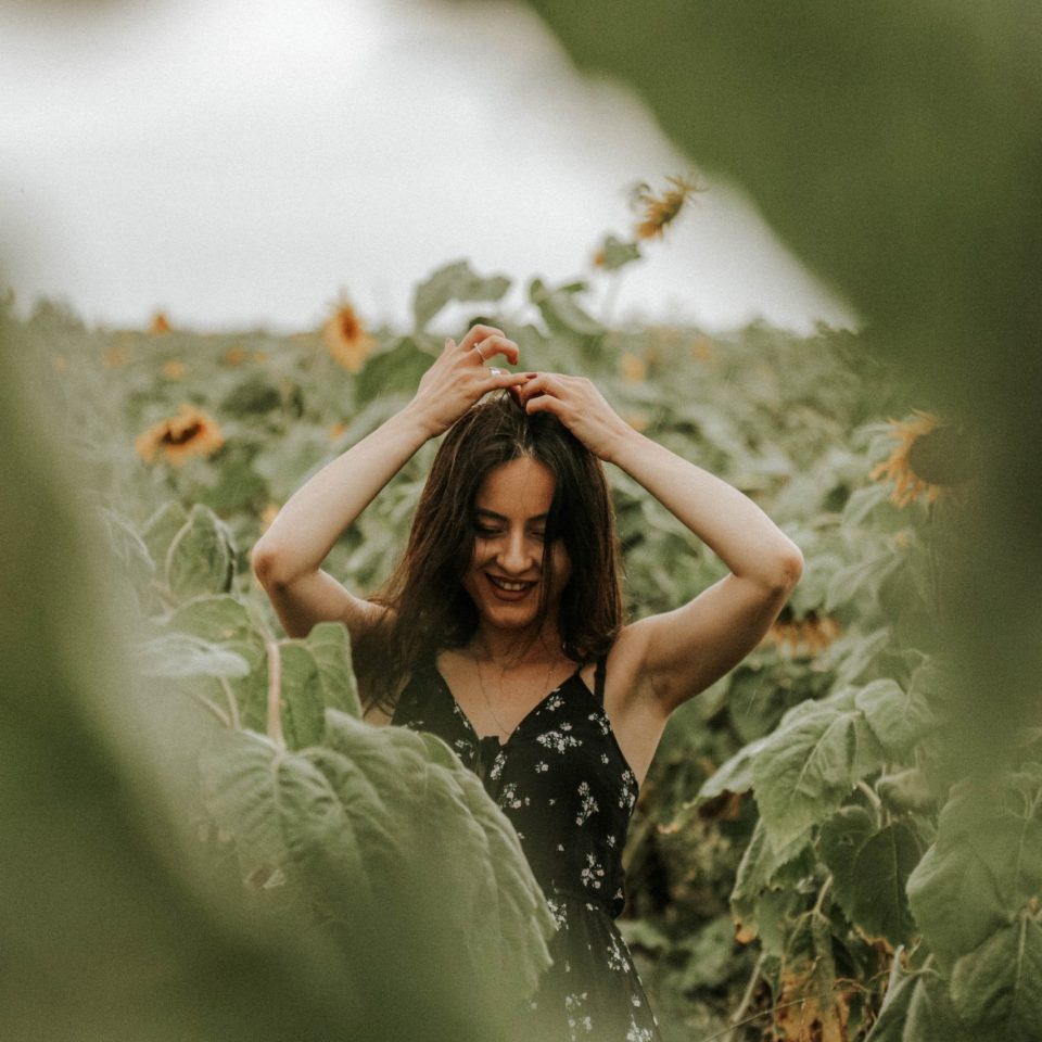 young-woman-standing-sunflower-farm young-woman-standing-sunflower-farm